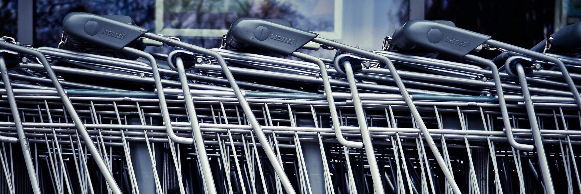 Rows of stacked metal shopping carts forming a repetitive industrial pattern.